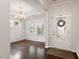 Inviting foyer with hardwood floors and a decorative front door at 143 Thornbury St, Clayton, NC 27527