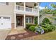 Inviting front porch with a stone wall, a wreath on the door, and beautiful landscaping at 143 Thornbury St, Clayton, NC 27527