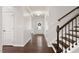 Hallway features hardwood floors, staircase, and view of the front door at 143 Thornbury St, Clayton, NC 27527