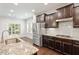 Bright kitchen featuring granite countertops, stainless steel appliances, and hardwood floors at 143 Thornbury St, Clayton, NC 27527