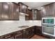 Gourmet kitchen boasts granite countertops, stainless steel appliances, and custom cabinetry at 143 Thornbury St, Clayton, NC 27527