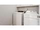 Convenient laundry room equipped with a washer and dryer and overhead cabinets at 143 Thornbury St, Clayton, NC 27527