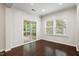 Living room features hardwood floors, bright windows, and sliding glass door to the patio at 143 Thornbury St, Clayton, NC 27527