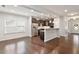 Open-concept living room with a view of the kitchen and stainless steel appliances at 143 Thornbury St, Clayton, NC 27527