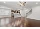 Open concept living room with hardwood floors leading to a modern kitchen at 143 Thornbury St, Clayton, NC 27527