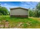 Back of house with gray siding and brick foundation at 150 Will Woods Way, Franklinton, NC 27525