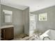 Bathroom with a glass enclosed shower, soaking tub, a wood vanity with sink and a window at 150 Will Woods Way, Franklinton, NC 27525