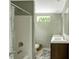 Bathroom with a shower and tub, a marble-look double sink countertop, and a window at 150 Will Woods Way, Franklinton, NC 27525