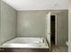 Bright bathroom with a soaking tub and a dark wood vanity at 150 Will Woods Way, Franklinton, NC 27525