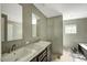 A bathroom with double sinks, neutral walls, and a large mirror provides spacious comfort at 150 Will Woods Way, Franklinton, NC 27525