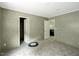 A cozy bedroom with gray carpet has a closet and view to a living area; ready for personalized touches at 150 Will Woods Way, Franklinton, NC 27525