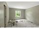 A bright bedroom with a window and gray carpet, offering a serene space at 150 Will Woods Way, Franklinton, NC 27525