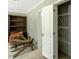 Bedroom with closet organizer and shelving with an open white door and furniture at 150 Will Woods Way, Franklinton, NC 27525