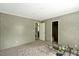 Bedroom with neutral gray carpet and view to living area offers simple comfort at 150 Will Woods Way, Franklinton, NC 27525