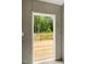 Bright doorway view of a wooden deck surrounded by natural landscape at 150 Will Woods Way, Franklinton, NC 27525