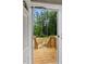 View from inside the door to the porch outside and the surrounding trees at 150 Will Woods Way, Franklinton, NC 27525