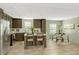 Bright kitchen with an island, breakfast bar, stainless appliances and an adjacent breakfast nook at 150 Will Woods Way, Franklinton, NC 27525