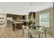 Cozy kitchen with dark wood cabinets, an island, and an adjacent dining area at 150 Will Woods Way, Franklinton, NC 27525