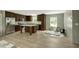 Features a kitchen with dark wood cabinetry, a stainless-steel refrigerator and an island with a stone countertop at 150 Will Woods Way, Franklinton, NC 27525