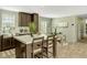 Bright kitchen featuring an island, breakfast bar, stainless sink, and an adjacent breakfast nook at 150 Will Woods Way, Franklinton, NC 27525