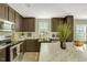Modern kitchen with stainless steel appliances, marble countertops, and ample cabinet space at 150 Will Woods Way, Franklinton, NC 27525