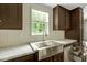 A kitchen sink with a stainless steel faucet and marble countertops at 150 Will Woods Way, Franklinton, NC 27525