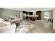 Open-concept space features a living area with neutral furniture and a kitchen with dark wood cabinetry at 150 Will Woods Way, Franklinton, NC 27525