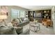 Open-concept living room with comfortable furniture and a built-in entertainment center at 150 Will Woods Way, Franklinton, NC 27525