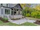 Back porch with stone fireplace is ideal for outdoor entertaining, featuring a built-in fire pit and covered seating area at 15517 Possum Track Rd, Raleigh, NC 27614