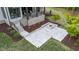 Beautiful backyard patio area with a stone fire pit perfect for entertaining and relaxing, complete with manicured landscaping at 15517 Possum Track Rd, Raleigh, NC 27614