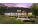 Expansive backyard featuring outdoor fireplace, covered patio and lush landscaping at 15517 Possum Track Rd, Raleigh, NC 27614
