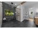 Modern bathroom featuring a glass shower, soaking tub, and large window overlooking a beautiful outdoor view at 15517 Possum Track Rd, Raleigh, NC 27614