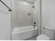 Bathroom featuring a shower over the tub with white subway tile and a gray grout at 15517 Possum Track Rd, Raleigh, NC 27614