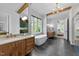 Bright bathroom featuring double vanities, a freestanding tub, and a chandelier, creating a luxurious space at 15517 Possum Track Rd, Raleigh, NC 27614