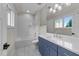 Bathroom features a blue vanity with white countertops and a shower over the tub at 15517 Possum Track Rd, Raleigh, NC 27614