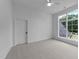 Bright bedroom featuring a large window and neutral carpeting, offering a serene and comfortable space at 15517 Possum Track Rd, Raleigh, NC 27614