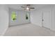 Bedroom with carpeted floors, two windows, and white trim at 15517 Possum Track Rd, Raleigh, NC 27614