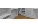 Well-organized walk-in closet with built-in shelving and hanging rods, offering ample storage space at 15517 Possum Track Rd, Raleigh, NC 27614