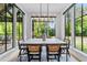 Bright dining room with large windows offering scenic views and a modern chandelier at 15517 Possum Track Rd, Raleigh, NC 27614