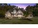 Stunning two-story stone home featuring manicured lawn and a side-entry garage on a wooded lot at 15517 Possum Track Rd, Raleigh, NC 27614
