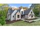 Beautifully landscaped front exterior of the home featuring brick and stone accents, manicured lawn, and welcoming curb appeal at 15517 Possum Track Rd, Raleigh, NC 27614