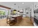 Bright, open kitchen featuring a large center island, pendant lighting, and modern appliances at 15517 Possum Track Rd, Raleigh, NC 27614