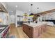 Open-concept kitchen with large center island, stainless steel appliances, and hardwood floors at 15517 Possum Track Rd, Raleigh, NC 27614
