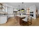Modern kitchen with large island, stainless steel appliances, and custom cabinets at 15517 Possum Track Rd, Raleigh, NC 27614