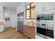 Gourmet kitchen featuring stainless steel appliances, custom cabinetry with glass display, and elegant countertops at 15517 Possum Track Rd, Raleigh, NC 27614