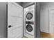 Convenient laundry closet with a stacked washer and dryer, maximizing space efficiency in the home at 15517 Possum Track Rd, Raleigh, NC 27614