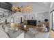 Open-concept living room with a fireplace, vaulted ceiling, and stylish decor at 15517 Possum Track Rd, Raleigh, NC 27614
