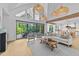 Inviting living room with vaulted ceilings, oversized windows, and stylish furniture at 15517 Possum Track Rd, Raleigh, NC 27614