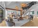 Spacious living room with an open staircase, modern lighting, and seamless flow to the kitchen at 15517 Possum Track Rd, Raleigh, NC 27614