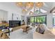 Bright living room with a cozy fireplace, large windows, and comfortable seating at 15517 Possum Track Rd, Raleigh, NC 27614